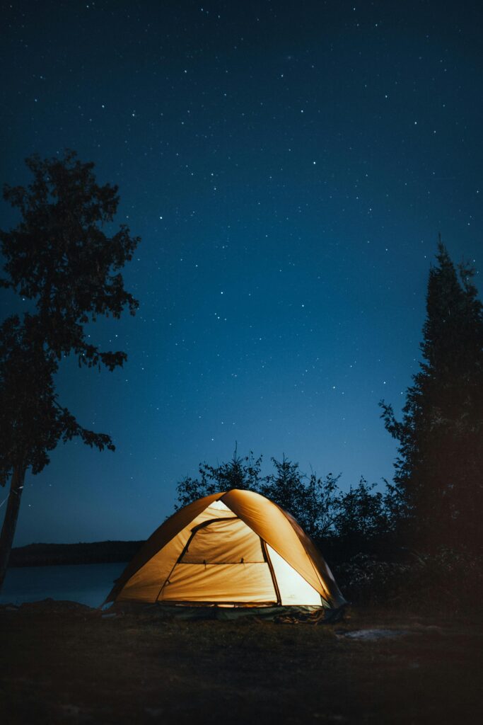 A serene campsite under a starry sky in Ely, Minnesota. Perfect outdoor adventure setting.